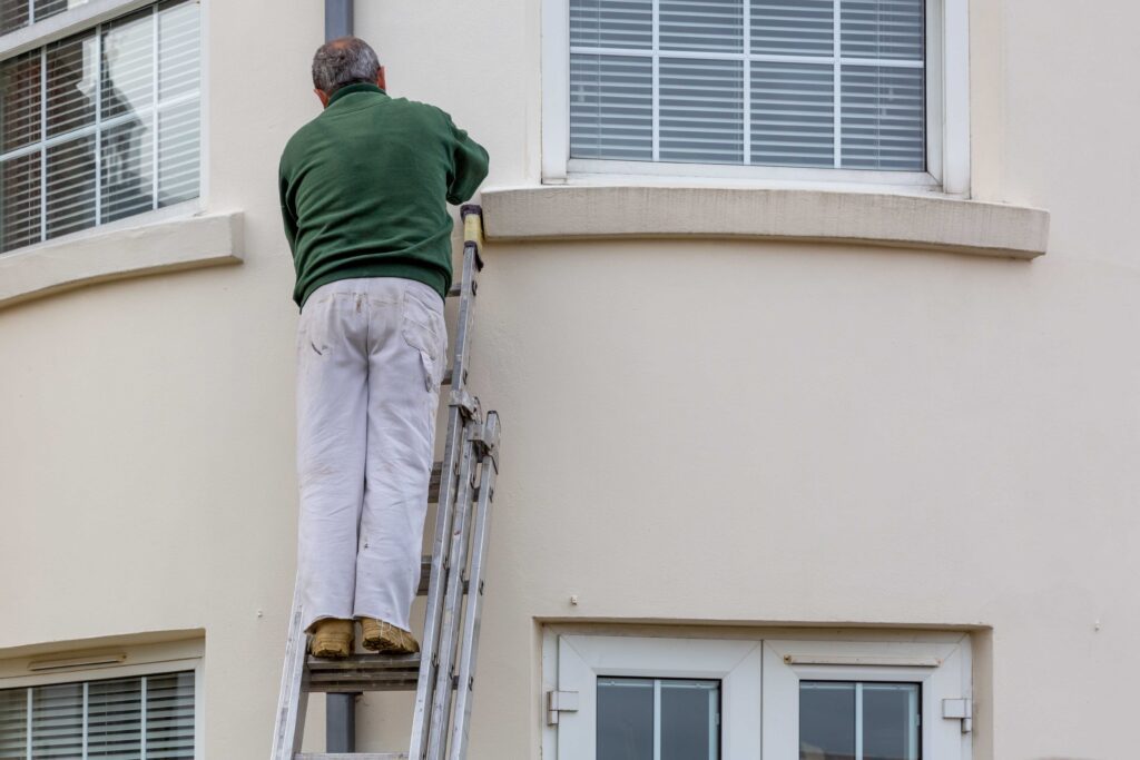 AdobeStock_386751496 (1) image of man on ladder painting
